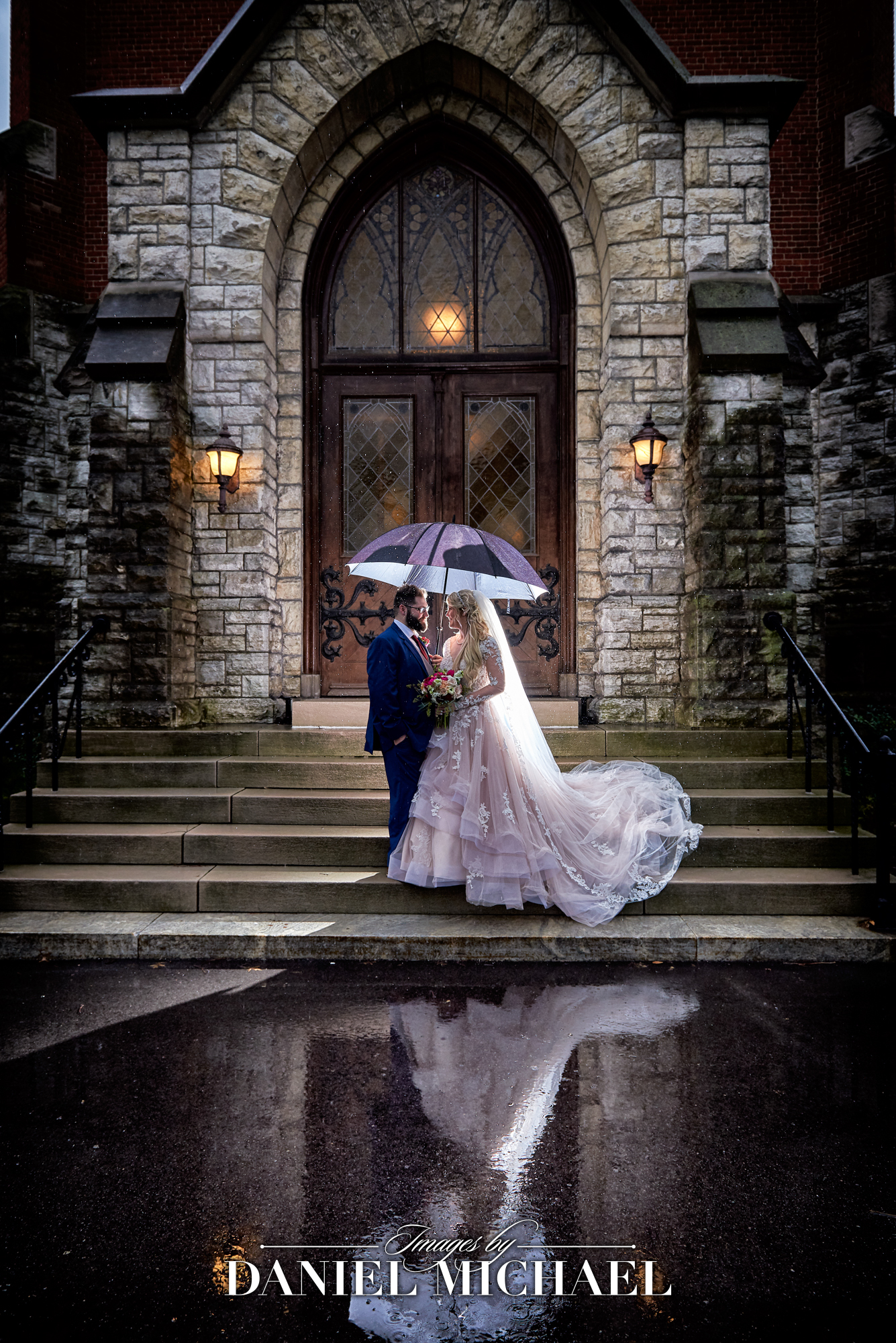Wedding Photographer captures rainy photo with umbrella and reflection